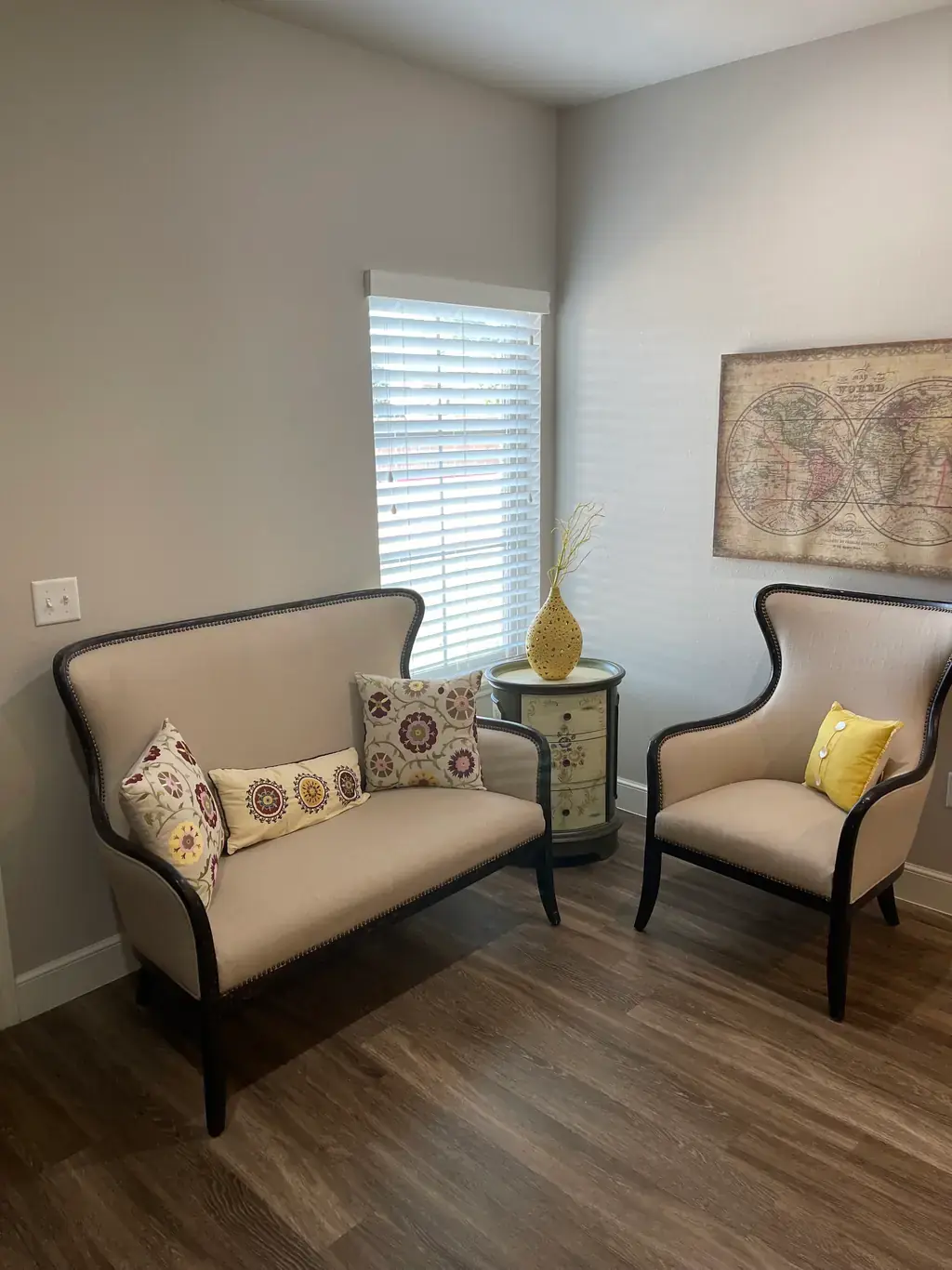 The waiting area at The Hope Exchange, with a cream settee and wingback chair